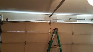 Qualified technicians replace a broken garage door