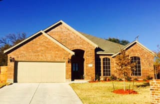 New construction double steel garage door install and repair on a home in Lake Worth Texas by Action Garage Doors Plano Tx