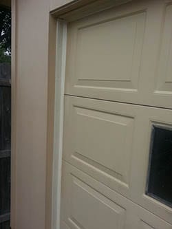 A new residential steel garage door with a weather seal installed to prevent water damage in a home in Garland Texas by Technician 2