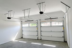 Residential house two car garage interior displaying garage door opener. Action Garage Door repair replace install in Pflugerville a suburb of Austin Texas