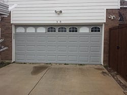 A window garage door with broken windows in need of repair or install that Action Garage Doors sent Alfredo their highly qualified technician