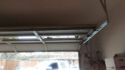 A new residential steel garage door roller replaced in Dallas Texas by a highly qualified technician at Action Garage Door of Plano Tx