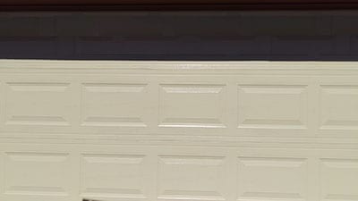 An older residential home in Mckinney Texas having an aged garage door replaced with a new steel door at 6209 Calloway Tx