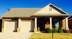 Two beautiful single car garage doors installed to repair aging garage doors on a home in Haslet Texas by Action Garage Doors of Plano