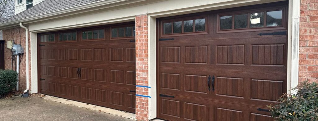A new set of wooden garage doors with window on the top.