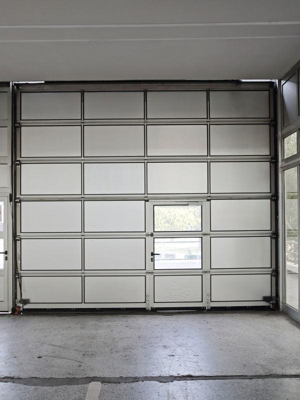A steel sectional garage door in an industrial facility. 