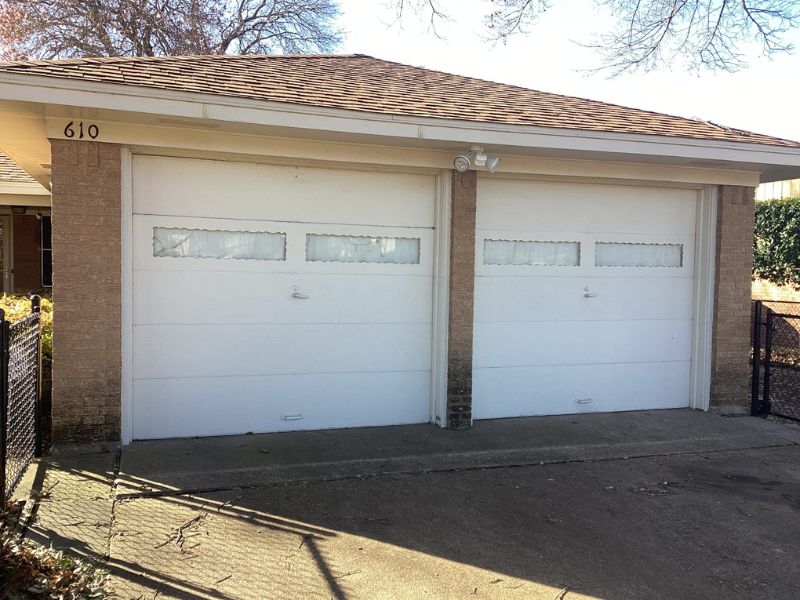Two sets of garage doors on a residential home in Texas.