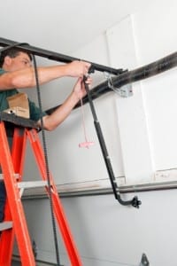 Technician working on fixing a garage door