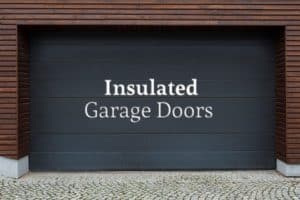 A steel garage door that's been painted black with the words "Insulated Garage Doors"
