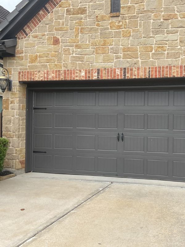 A new garage door on a brick residential house.