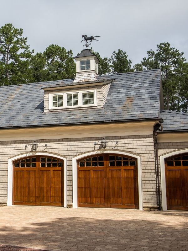 Carriage house wood garage doors on a residential home. 